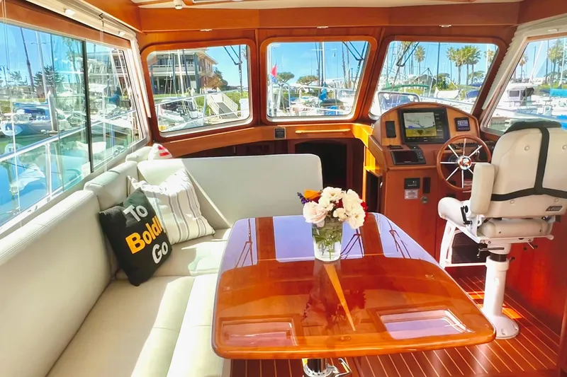 Luxurious interior of 2016 Sabre 38 Salon Express yacht with elegant seating and helm.