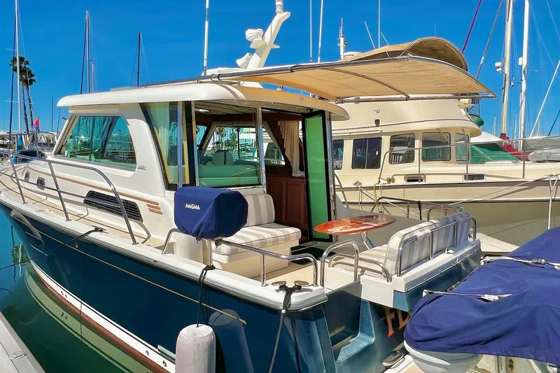2016 Sabre 38 Salon Express yacht docked at marina, featuring elegant design and spacious deck.
