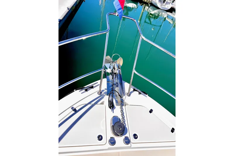 Bow view of 2016 Sabre 38 Salon Express with anchor and railing in marina.