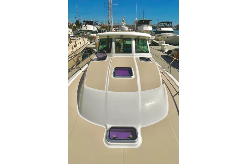 2016 Sabre 38 Salon Express yacht docked in a marina, showcasing sleek design and hatches.