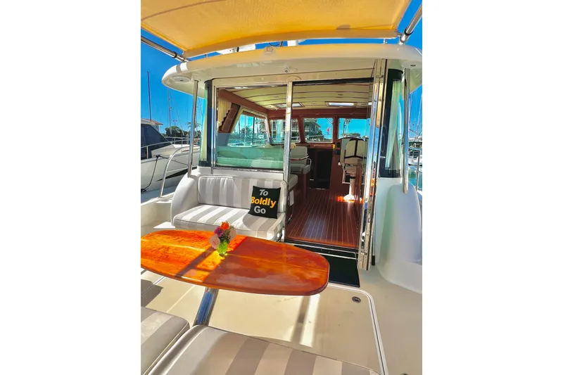 2016 Sabre 38 Salon Express yacht interior with seating, table, and "To Boldly Go" pillow.
