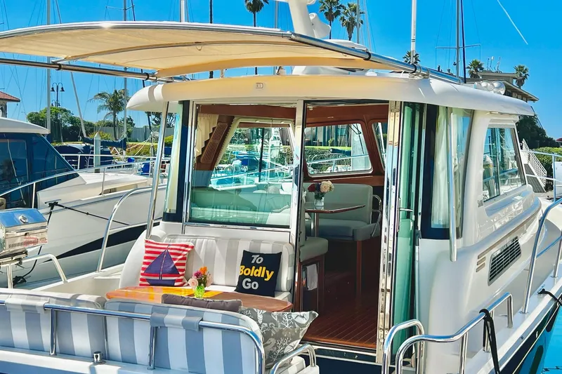 2016 Sabre 38 Salon Express yacht docked, featuring a stylish outdoor seating area.