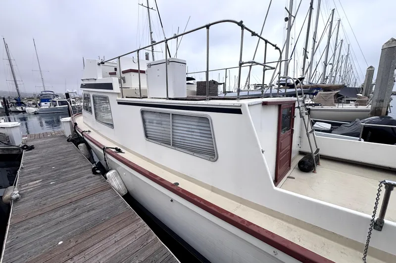1974 Skookum 34 boat docked at marina, featuring classic design and spacious deck.