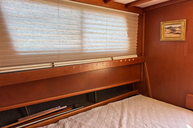 Interior of a 1974 Skookum 34 boat with wooden paneling and a small framed painting.