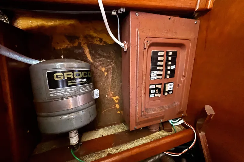 Electrical panel and Groco pressure tank inside a 1974 Skookum 34 boat.