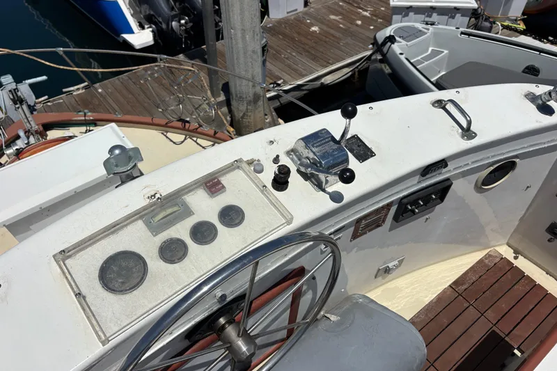Cockpit of a 1974 Skookum 34 boat with steering wheel and control panel.
