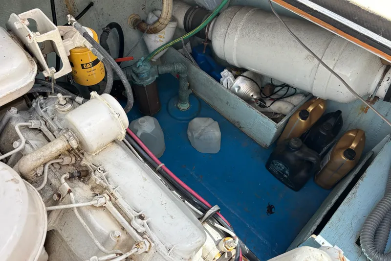 Engine compartment of a 1974 Skookum 34 boat with various mechanical components.