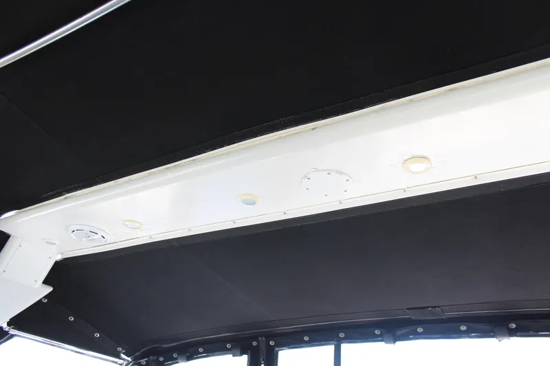 Interior ceiling of a 1996 Trojan 440 Express boat with lighting fixtures.