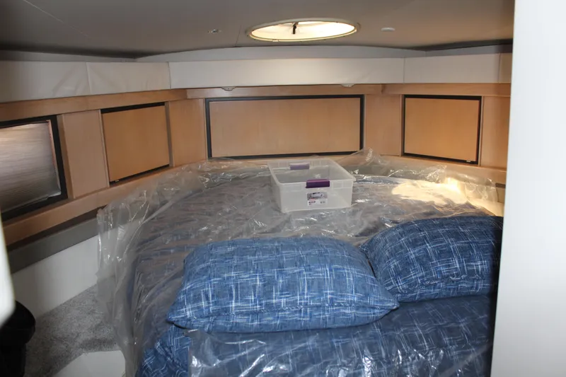 1996 Trojan 440 Express cabin with blue bedding and storage box.