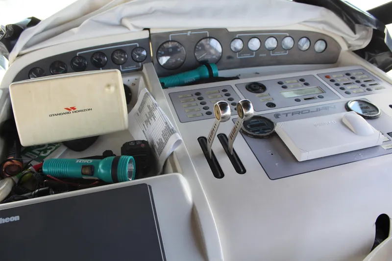 Control panel of a 1996 Trojan 440 Express boat with various instruments and equipment.