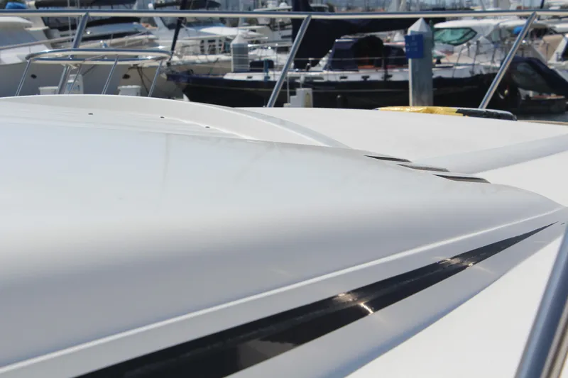 1996 Trojan 440 Express yacht, sleek design, docked in marina.