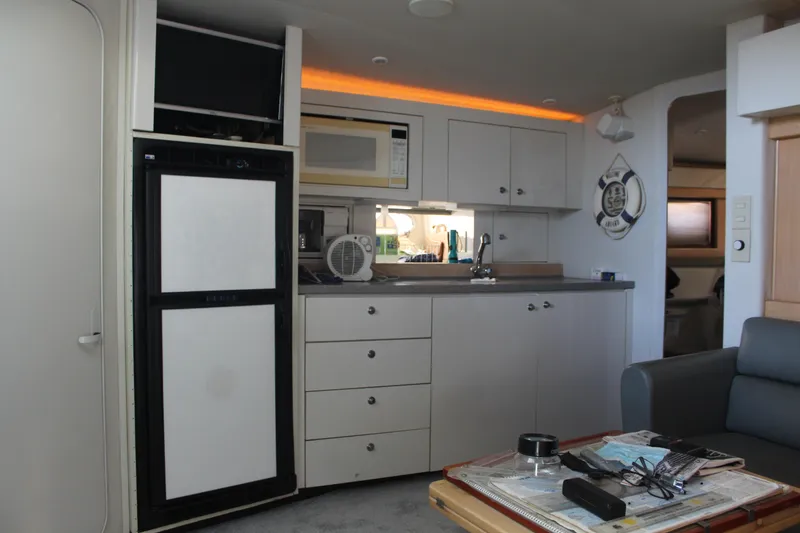 Interior of a 1996 Trojan 440 Express yacht with kitchenette and modern amenities.