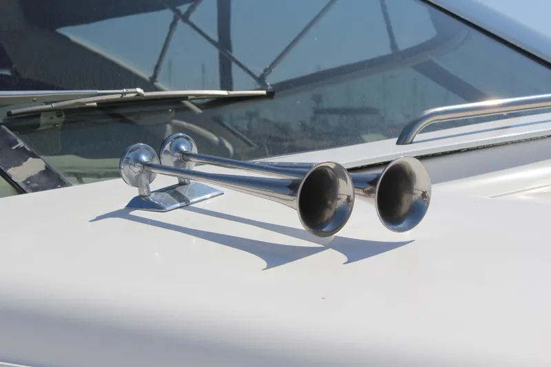 Chrome horns on a 1996 Trojan 440 Express boat deck.