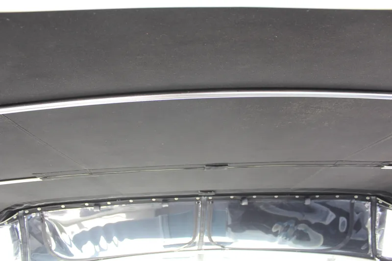 Interior roof of a 1996 Trojan 440 Express boat, featuring sleek black paneling.