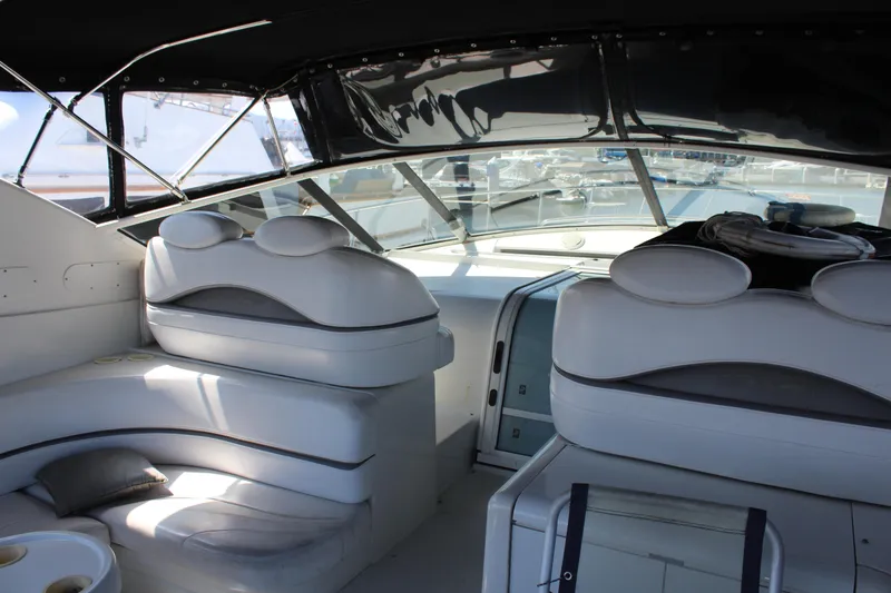 Interior of a 1996 Trojan 440 Express yacht with white leather seating.