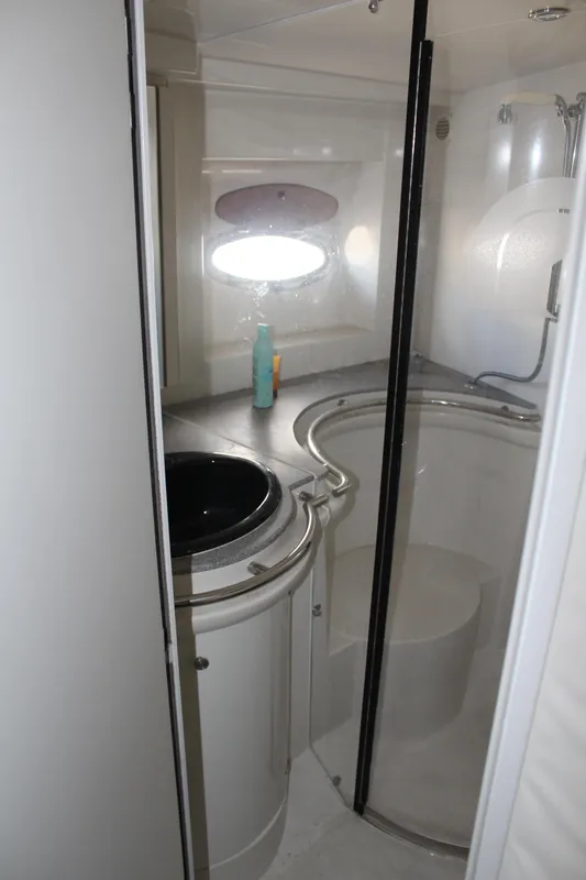 Bathroom interior of a 1996 Trojan 440 Express yacht with modern fixtures.