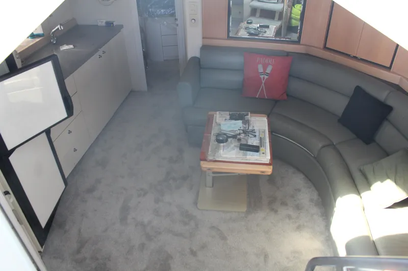 Interior of 1996 Trojan 440 Express yacht with curved seating and kitchenette.