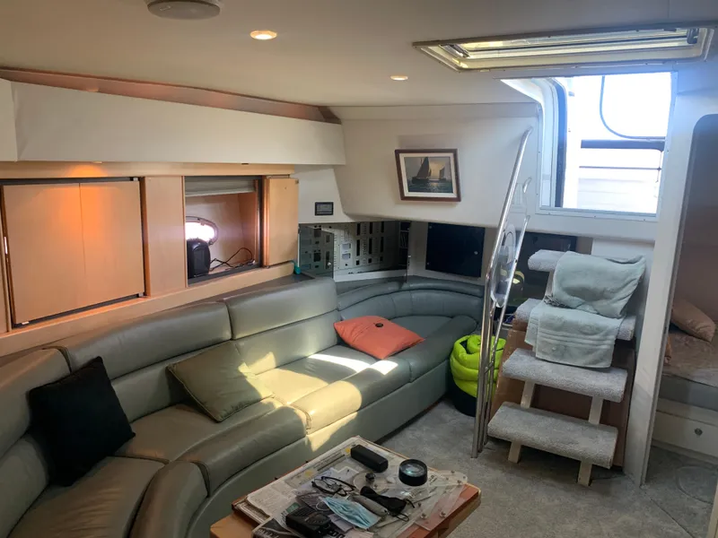 Interior of a 1996 Trojan 440 Express yacht with cozy seating and modern decor.