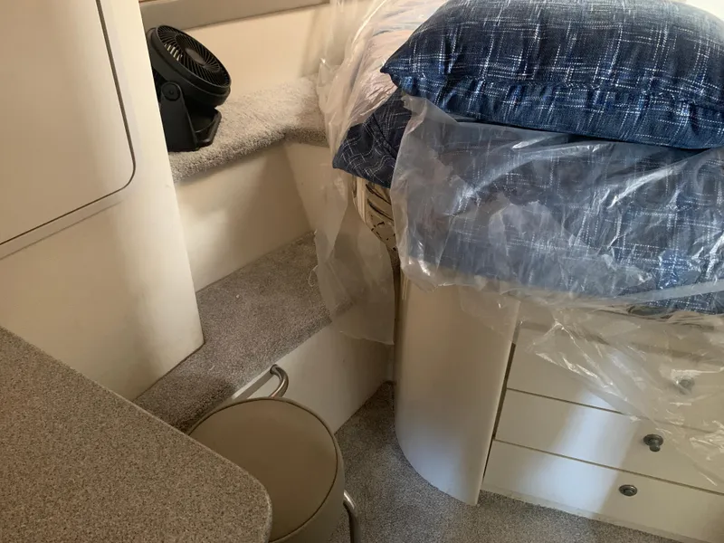Interior of 1996 Trojan 440 Express yacht with bed, fan, and storage.