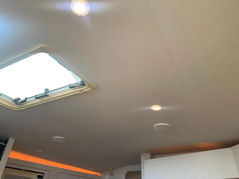 Ceiling interior of 1996 Trojan 440 Express boat with skylight and recessed lighting.