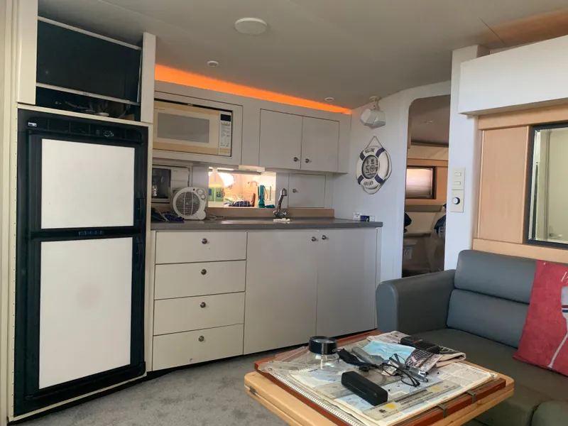 Interior of a 1996 Trojan 440 Express yacht with kitchenette and seating area.