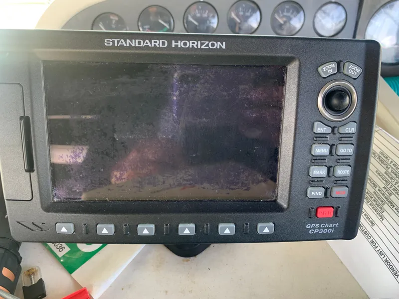 Standard Horizon GPS chart plotter on a 1996 Trojan 440 Express boat dashboard.