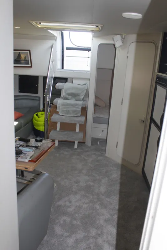 Interior of 1996 Trojan 440 Express yacht with modern furnishings and carpeted flooring.