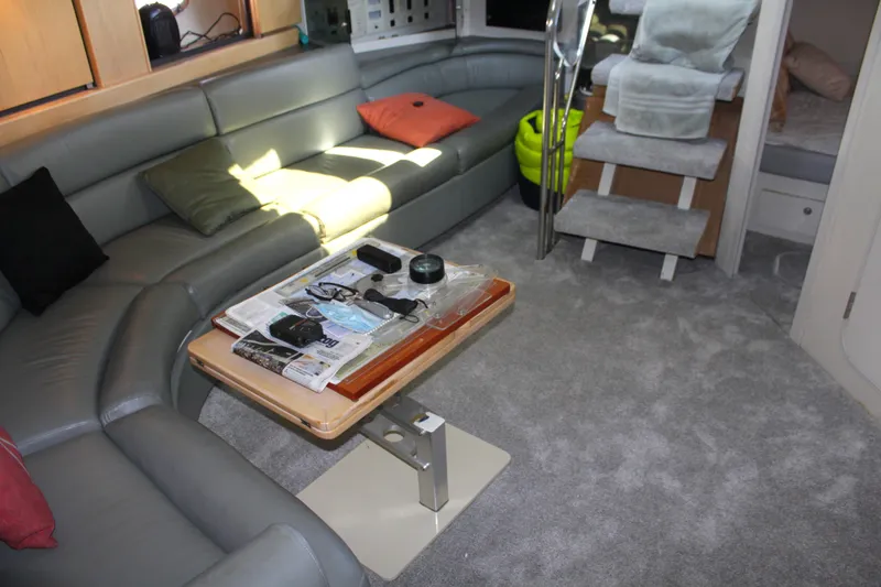Luxurious interior of a 1996 Trojan 440 Express yacht with plush seating and modern decor.