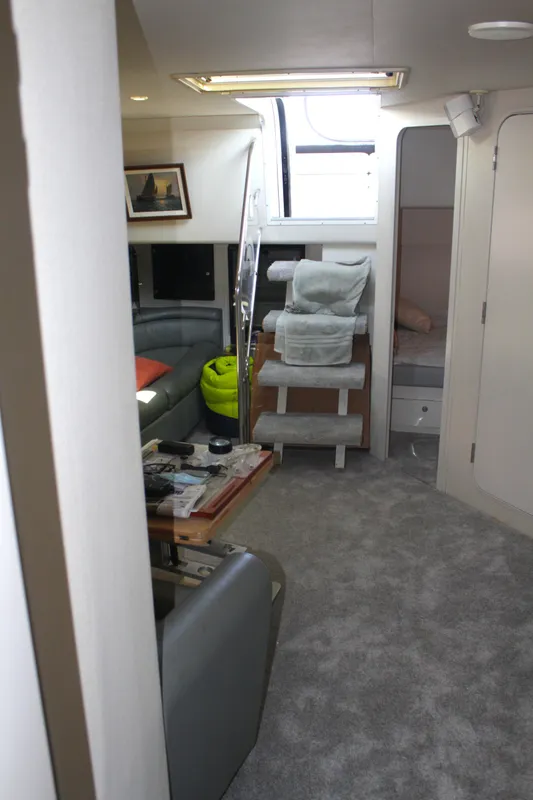 Interior of 1996 Trojan 440 Express yacht with modern furnishings and carpeted flooring.