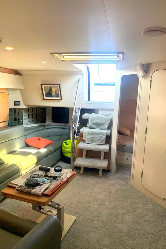 Interior of 1996 Trojan 440 Express yacht with cozy seating and modern decor.