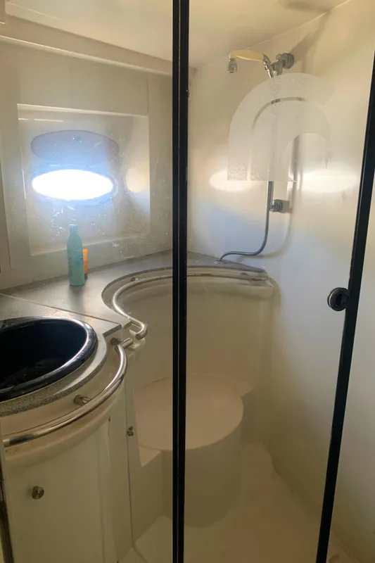 Bathroom interior of 1996 Trojan 440 Express yacht with shower and sink.