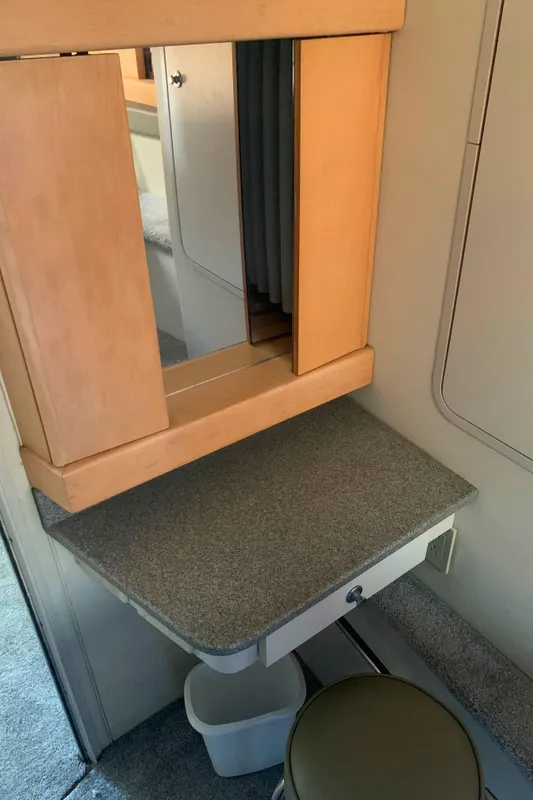 1996 Trojan 440 Express interior with vanity mirror and stool.
