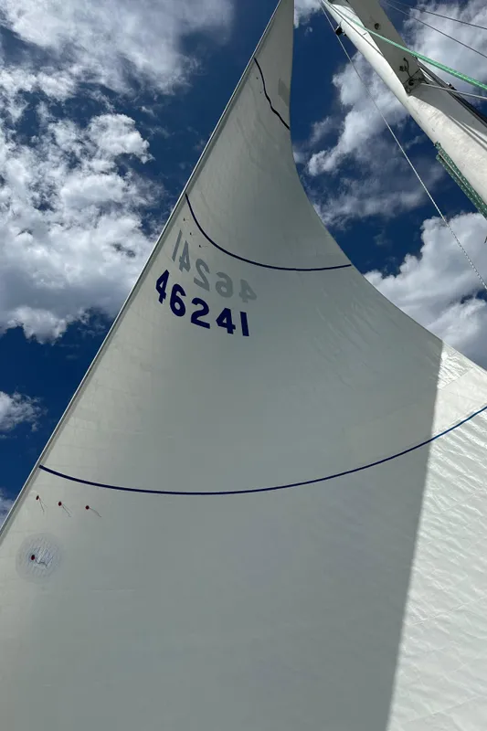 1985 C&C 41 sailboat with sail number 46241 under blue sky.