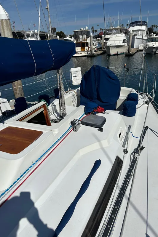 1985 C&C 41 sailboat docked in marina, sunny day.