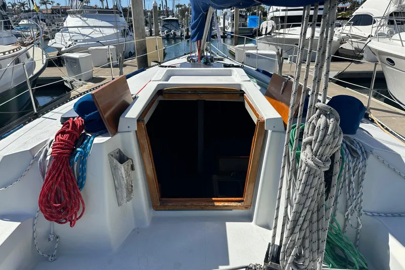 1985 C&C 41 sailboat in harbor, open cabin door.