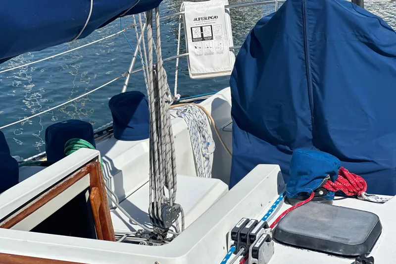 Cockpit of a 1985 C&C 41 sailboat with blue covers.