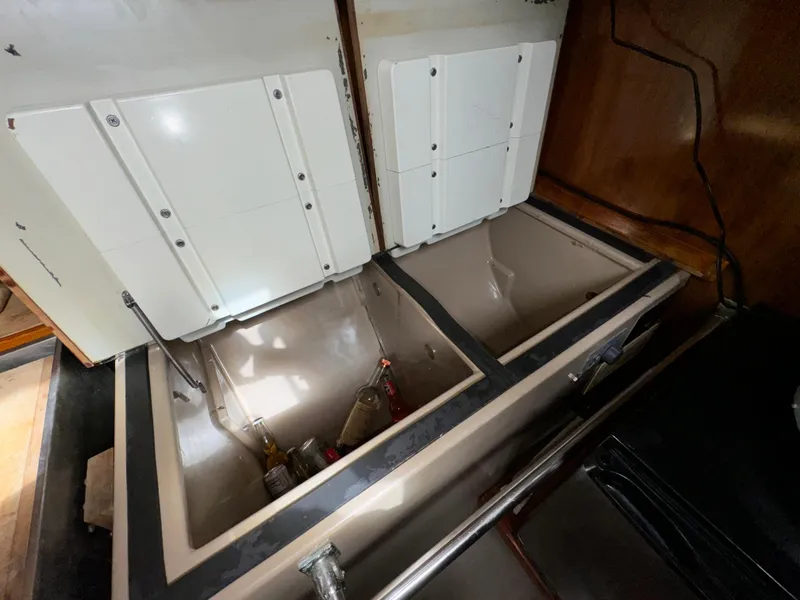 1985 C&C 41 yacht kitchen area with open storage compartments.