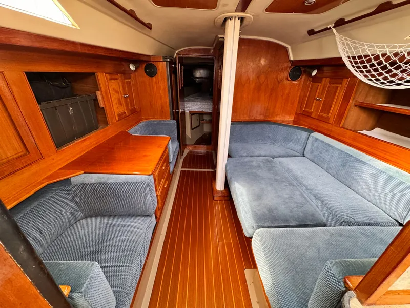 Interior of a 1985 C&C 41 yacht with blue upholstery.