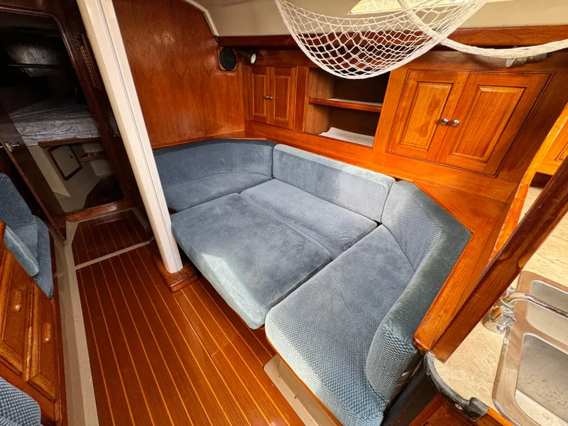 Interior of a 1985 C&C 41 yacht with blue upholstery.