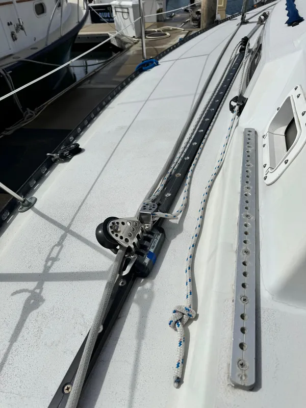 Deck of a 1985 C&C 41 sailboat with tracks and ropes.