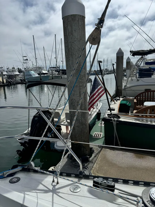 1985 C&C 41 sailboat docked in marina with American flag.