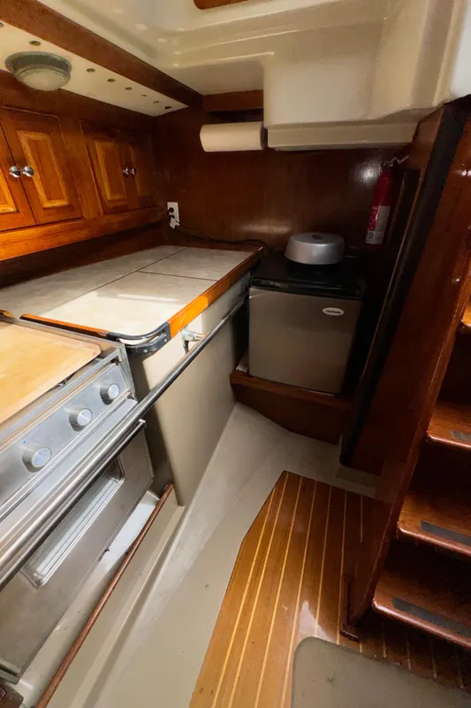 1985 C&C 41 yacht interior with kitchen and wood paneling.