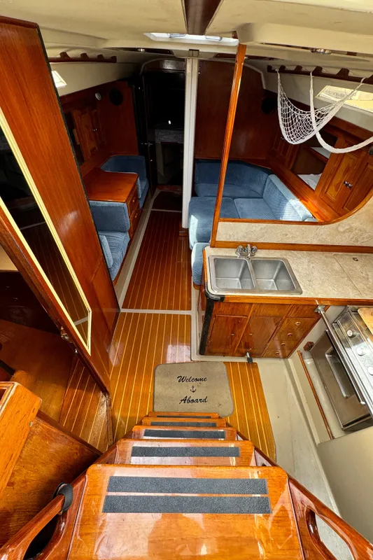 Interior of a 1985 C&C 41 yacht with wooden floors and kitchen.