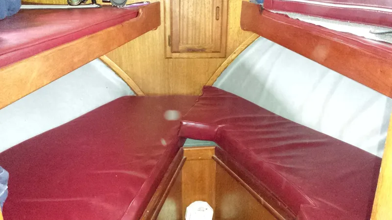 V-berth, with two upper bunks.