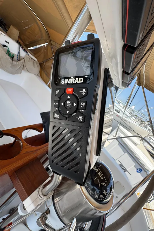 Handheld Simrad marine radio on a 1998 Catalina 36 MkII sailboat cockpit.