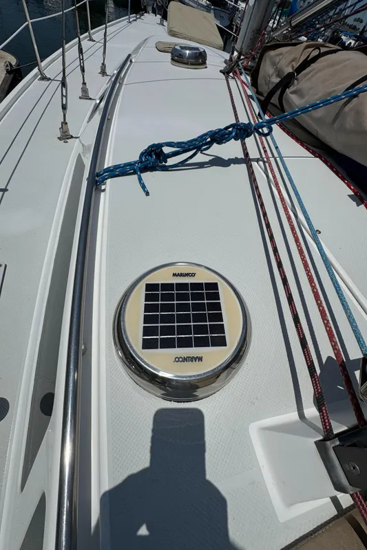 Deck of 1998 Catalina 36 MkII sailboat with solar vent and rigging.