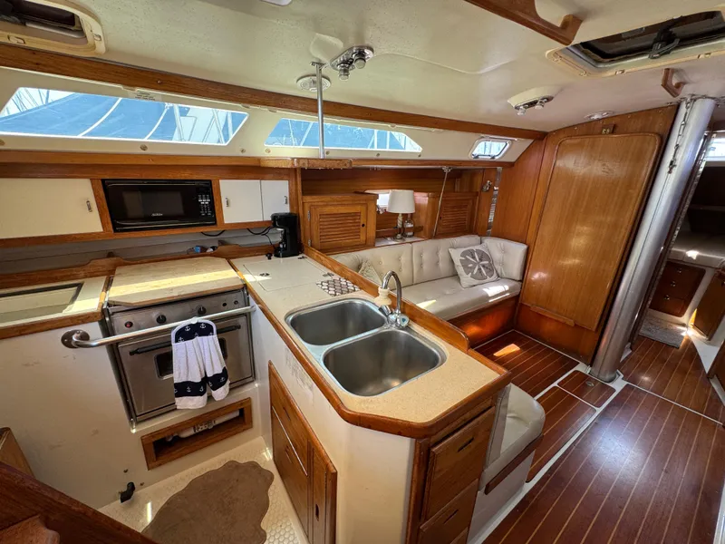 Interior of a 1998 Catalina 36 MkII sailboat with kitchen and seating area.