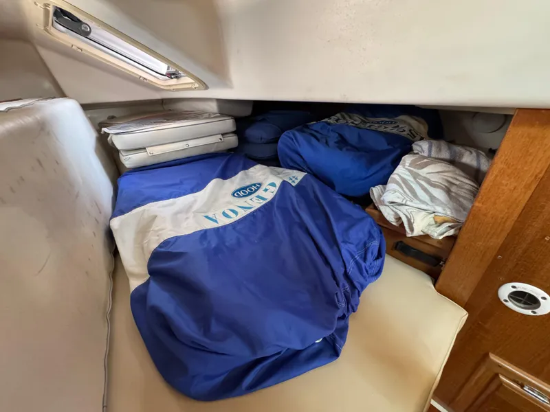 Interior cabin storage of 1998 Catalina 36 MkII sailboat with blue and white bags.