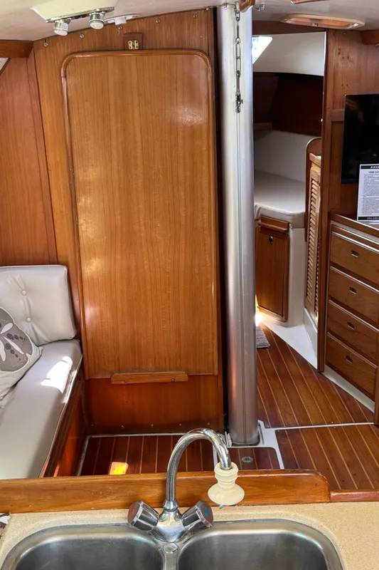 Interior of 1998 Catalina 36 MkII sailboat with wood paneling and cozy seating area.