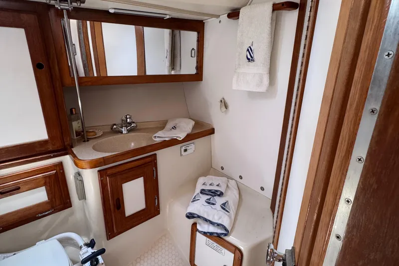 Bathroom interior of a 1998 Catalina 36 MkII yacht with wooden cabinetry.